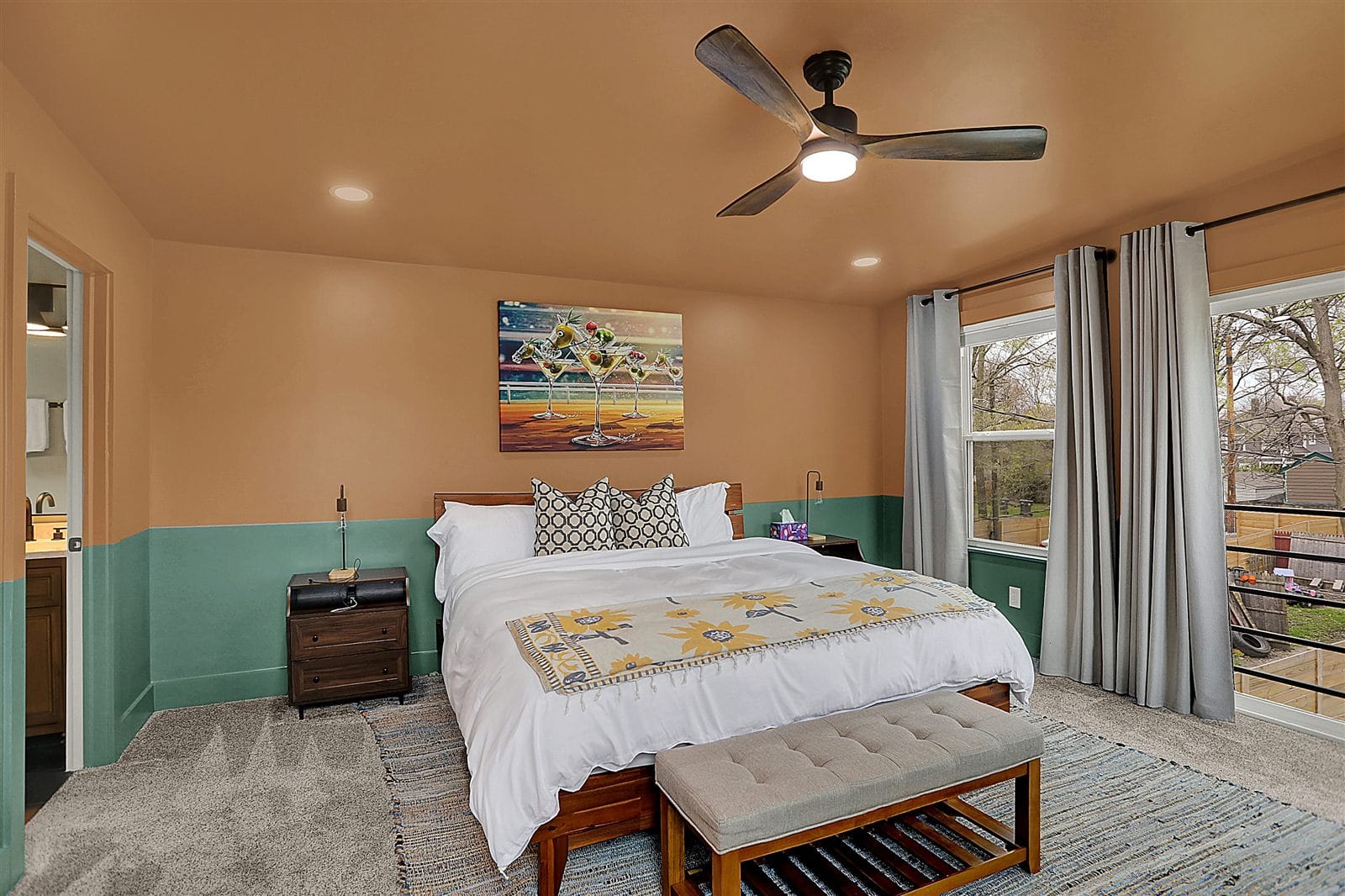 Upstairs king bedroom with vaulted ceiling, sage walls, and en-suite bathroom access