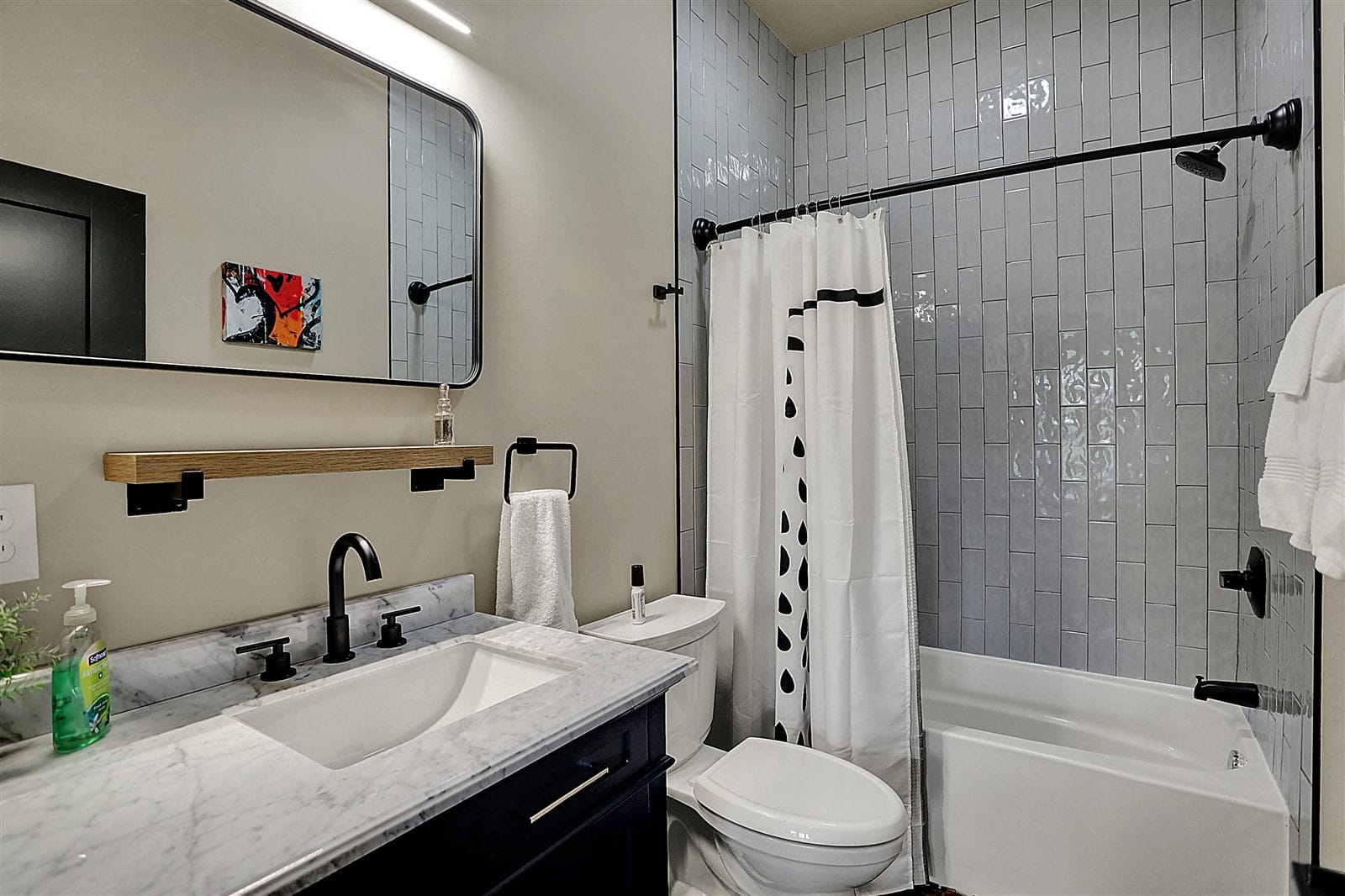Main-floor en-suite with double vanity, marble counter, and slate tile flooring