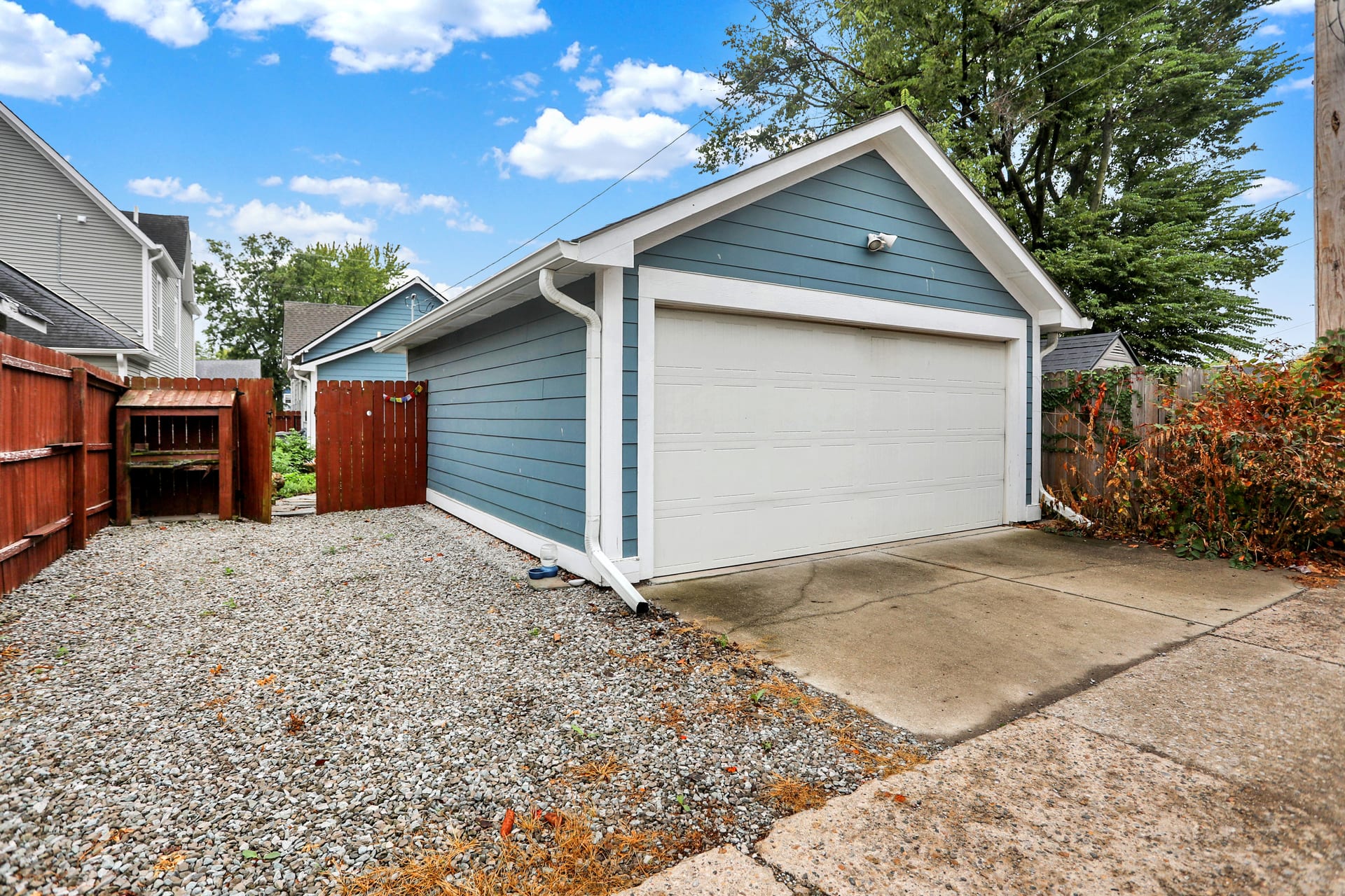Detached two-car garage at the alley, with side gate into the fenced backyard at The Sanders